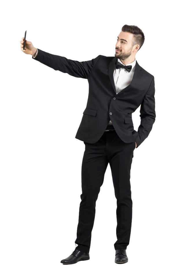 Man wearing a tailored black tuxedo at Precision Alterations Phoenix, taking a photo after fitting.