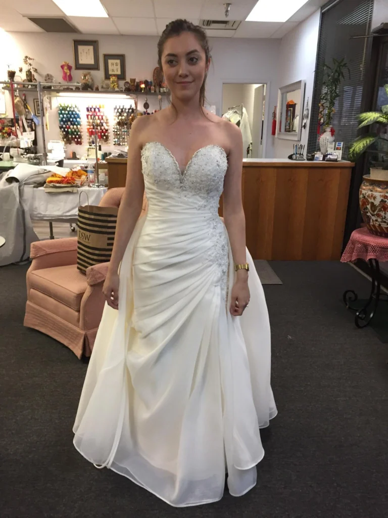 Smiling bride in perfectly fitted wedding dress after bridal gown alterations in Phoenix and Tucson