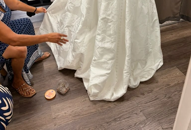 Precision Alterations in Phoenix adjusting the hem of a bridesmaid dress during bridesmaid dress alterations Phoenix.