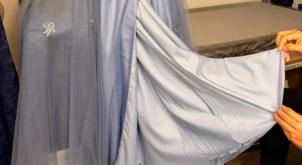 Precision Alterations in Phoenix checking the lining of a blue mother of the bride dress for bridesmaid dress alterations Phoenix.